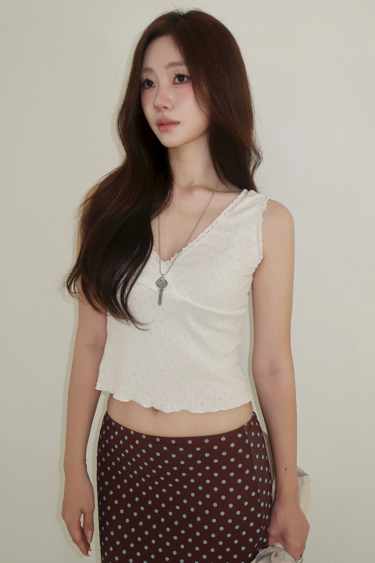 The Fairy Ruffle Sleeveless worn in the studio, the ruffle along the V-neck and over both shoulders